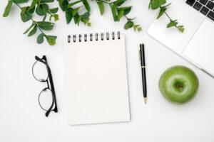 Glasses, pen, paper and glasses on white background.